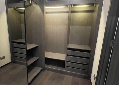 Spacious walk-in closet with built-in shelving and hanging space