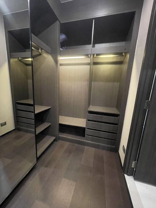 Spacious walk-in closet with built-in shelving and hanging space