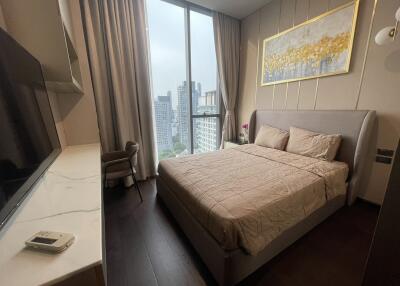 Modern bedroom with large window and city view