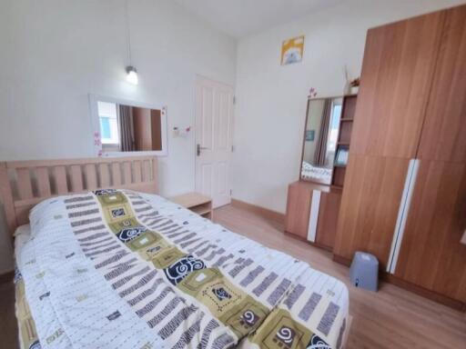 Spacious bedroom with wooden furniture and contemporary decor