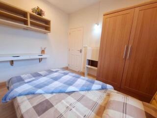 Cozy bedroom with wooden furniture