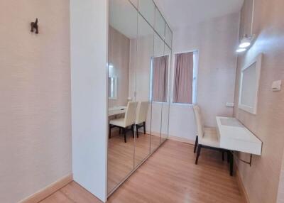 Bedroom with mirrored closet and study desk