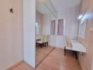 Bedroom with mirrored closet and study desk