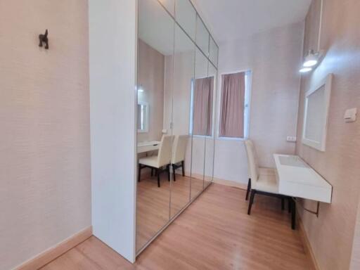 Bedroom with mirrored closet and study desk