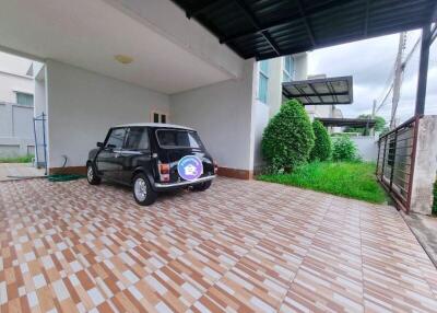 Spacious garage with a black car and tiled flooring