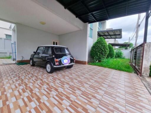 Spacious garage with a black car and tiled flooring