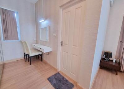 Bright bedroom with a vanity desk and two chairs