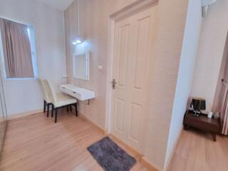 Bright bedroom with a vanity desk and two chairs