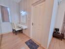 Bright bedroom with a vanity desk and two chairs