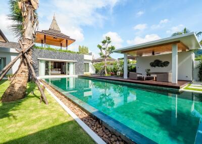 Luxury backyard with swimming pool and outdoor seating area.