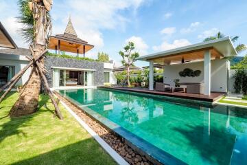 Luxury backyard with swimming pool and outdoor seating area.