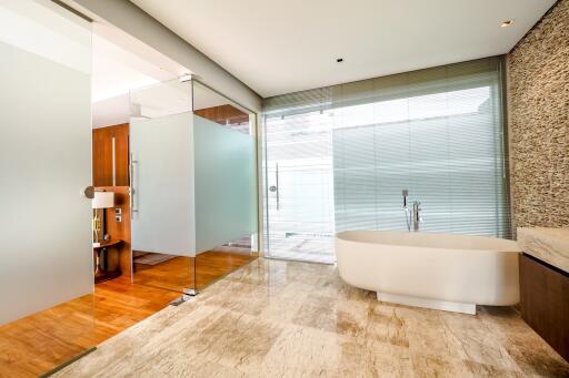 Modern bathroom with glass partitions and a bathtub