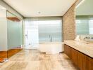 Modern bathroom with a large bathtub, glass shower, and wooden cabinets