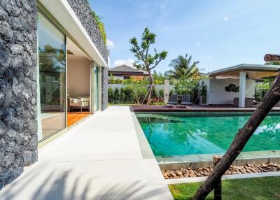 beautiful poolside view facing a modern building with large glass doors