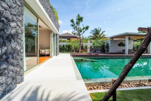 beautiful poolside view facing a modern building with large glass doors