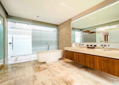 Spacious modern bathroom with freestanding bathtub and large vanity