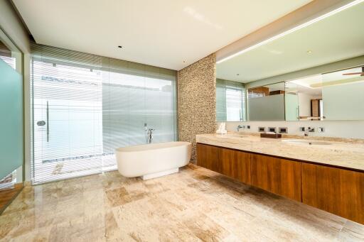 Spacious modern bathroom with freestanding bathtub and large vanity