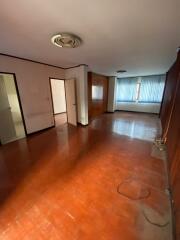 Spacious living room with wood flooring and large windows