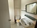 basic bathroom with white tiles and a sink