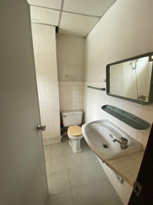 basic bathroom with white tiles and a sink