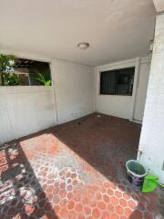 Covered patio with tiled floor and window