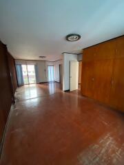 Spacious living room with wooden floor and built-in cabinets