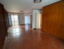 Spacious living room with wooden floor and built-in cabinets