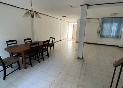 Spacious dining room with tile flooring and wooden dining set