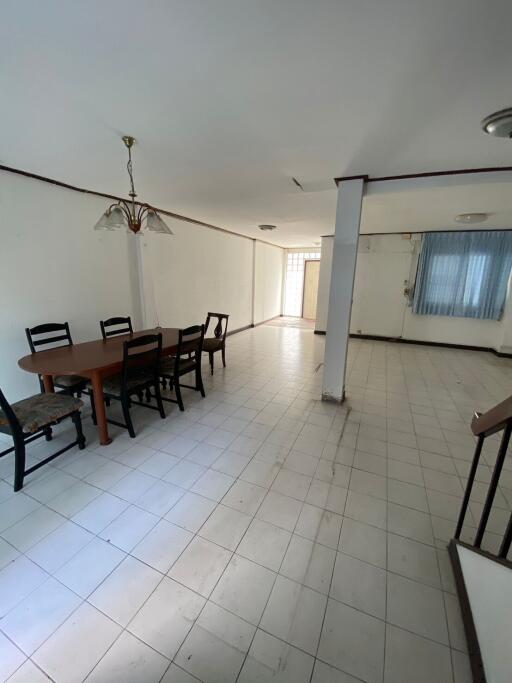 Spacious dining room with tile flooring and wooden dining set