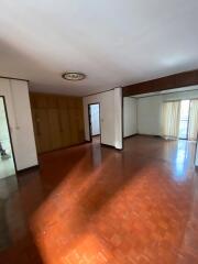 Spacious living room with hardwood floors and natural light