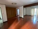 Spacious living room with hardwood floors and natural light