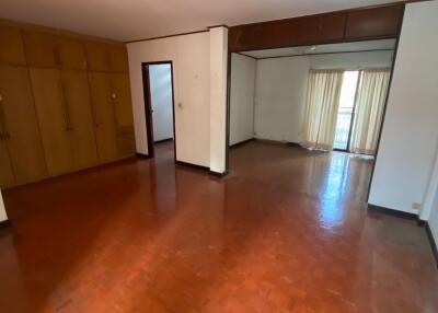 Spacious living room with hardwood floors and built-in wardrobes