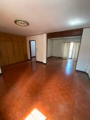 Spacious living room with hardwood floors and built-in wardrobes