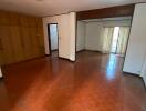 Spacious living room with hardwood floors and built-in wardrobes