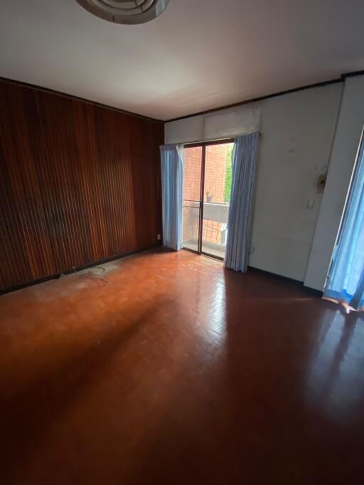 Empty living room with wooden wall and sliding door