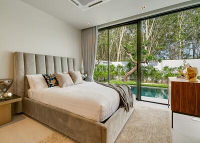 Luxurious bedroom with large windows and pool view