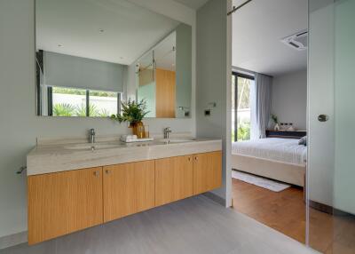 Modern bathroom with a view of the bedroom