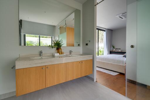 Modern bathroom with a view of the bedroom