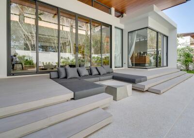 modern outdoor patio area with glass walls and seating