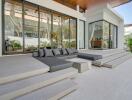 modern outdoor patio area with glass walls and seating