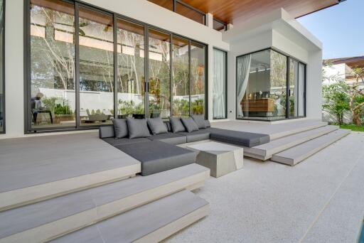 modern outdoor patio area with glass walls and seating