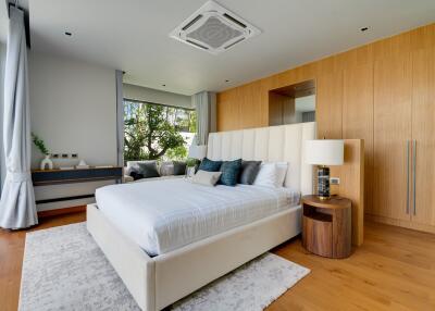 Modern bedroom with large bed and wooden accents