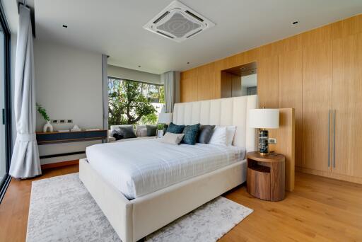 Modern bedroom with large bed and wooden accents