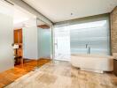 Modern bathroom with glass walls and a standalone bathtub