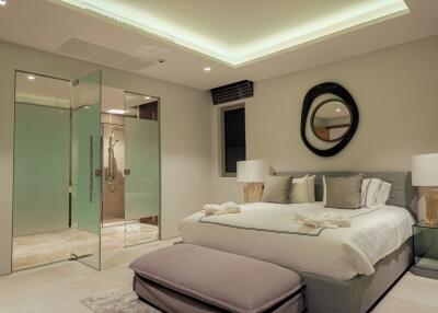 Modern bedroom with glass shower enclosure and ceiling lighting