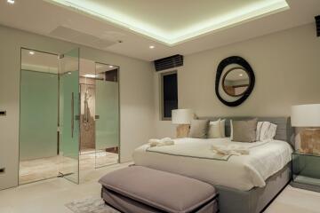 Modern bedroom with glass shower enclosure and ceiling lighting