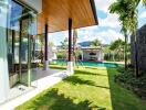 View of a modern outdoor space with a pool and garden