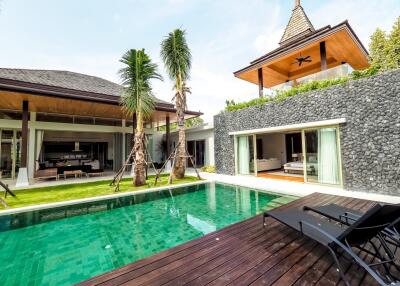 Outdoor view of a modern villa with a pool and lounge area