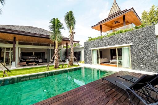 Outdoor view of a modern villa with a pool and lounge area