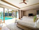 Spacious bedroom with a pool view and modern furnishings